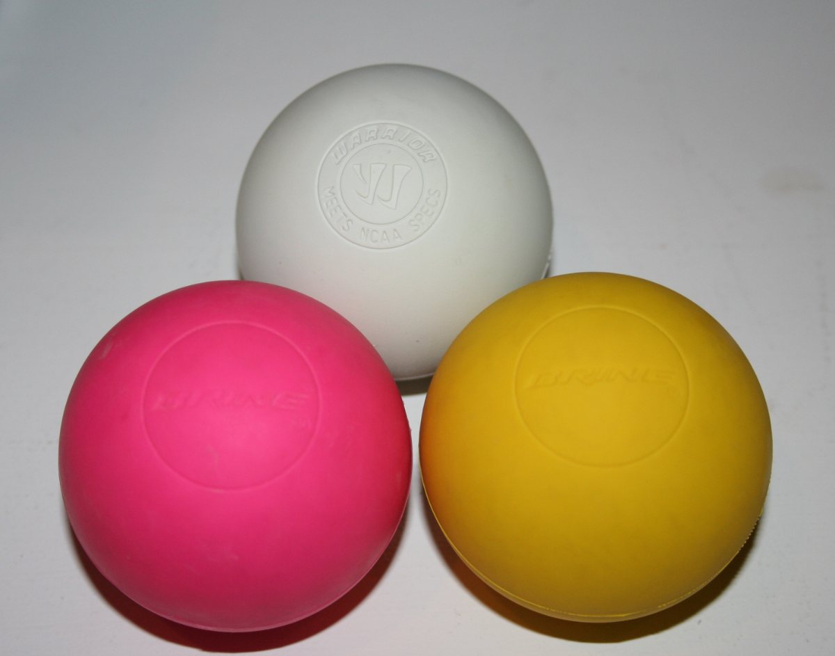 Tres pelotas lisas y duras de colores, como las que se usan para masaje.